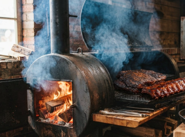 Wood-fired smoker with ribs slow-smoking